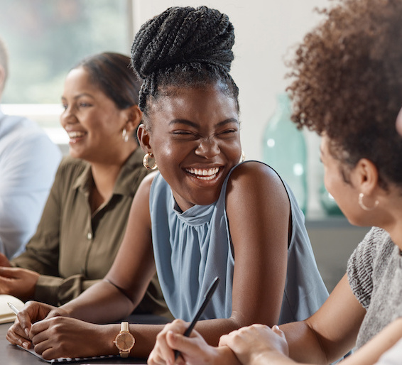 Skilled african american female employee working happily in office environment