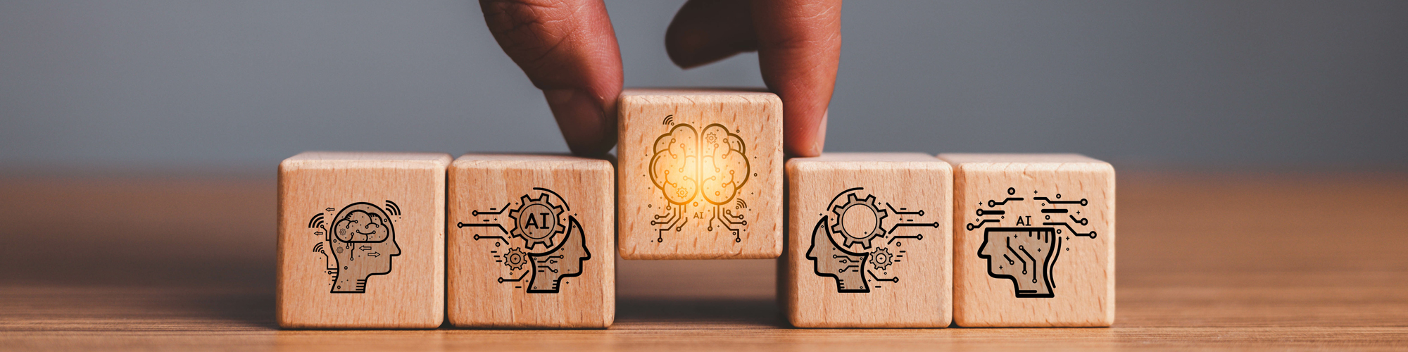 Person grabbing blocks with graphics of heads supposed to represent upskilling and reskilling